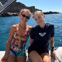 two girls sitting on a boat