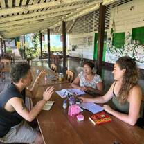 Two students studying with local teacher