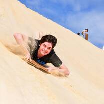 Teen sandboarding in Australia
