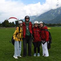 Teen travelers wearing paragliding gear in Switzerland