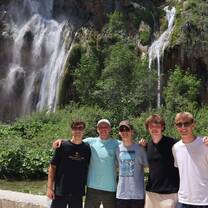 Teen travelers in front of a waterfall in Croatia