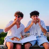 Boys eating pizza in Florence