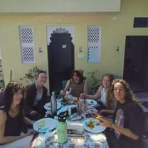 VOLUNTEERS HAVING BREAKFAST BEFORE HEADING TO VILLAGE
