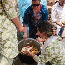 VOLUNTEERS DISTRIBUTING FRUIT SALAD TO VILLAGE CHILD CARE HOME