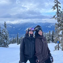 Two people smiling on a snowy mountain