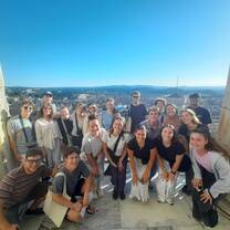 CET Florence students smiling at the top of the Duomo in Florence with views of city
