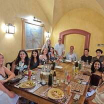A group of students sitting around a table with food for a farewell dinner