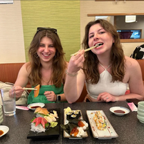 Two women eating Japanese food