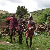 Maasai community members sharing traditional customs and knowledge with visiting students in Loita.