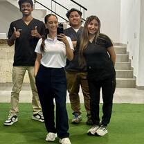 Group Selfie of 4 participants standing in front of mirror