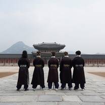 Teen travelers dressed in Korean Hanbok at Gyeongbokgung palace in Seoul.