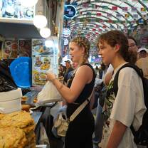 Teens buying traditional Korean food in a market in Seoul.