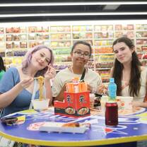 Three girls eating cup ramen and a convenience store in Seoul.
