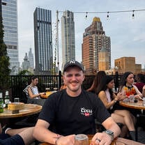 Man with a city skyline behind him in the USA