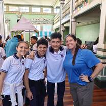 Volunteer helping Costa Rican students practice English through classroom activities and conversation in Heredia.