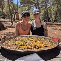 host family and student eating homemade Paella