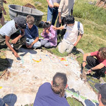 VISIONS Montana Blackfeet Participants drawing on the hide