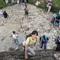 Spanish immersion student climbing the Tepozteco pyramid ruins in Tepoztlán, Mexico