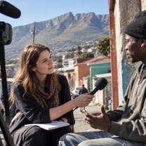 VAC journalism intern interviewing a local resident on a Cape Town street