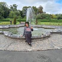 lady sitting in front of a waterfountain