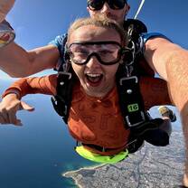 lady in skydiving gear in the air