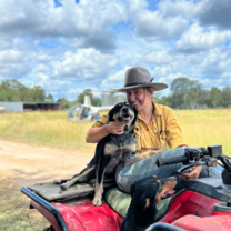 Lady on a dirt bike, holding a dog