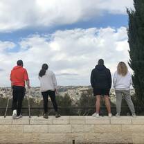 Friends looking out over the Tayelet at a view of the Old City
