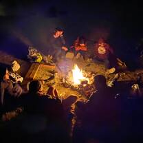 My friends and I sitting around a camp fire