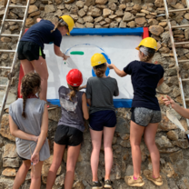 This was the final day working on our community service project! We had just finished building this wall and were in the process of painting a mural!