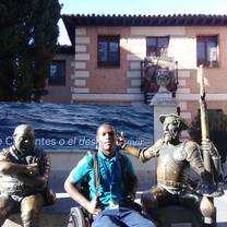 Sitting with Miguel Cervantes and Sancho Panza in front the Miguel de Cervantes Museum in Madrid, Spain 2019