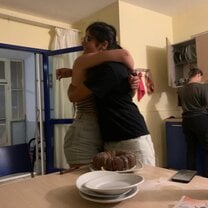 Hugging Débora because she made a "goodbye-cake"