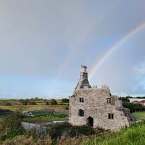 Double rainbow over castle ruins in Galway