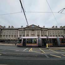 Trinity front gates with Luas tram