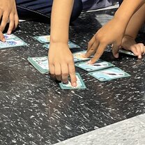 Playing cards with the kids at the respite center (faces hidden for privacy)