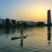 Paddle boarding on the Guadalquivir river at sunset