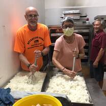 Marital Teamwork - Raking rice to prepare for serving later