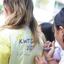 The students and staff signing our tops