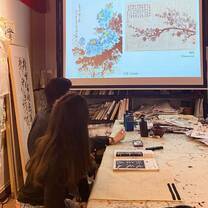 Taking a Chinese calligraphy lesson, one of the free cultural activities provided by the program.