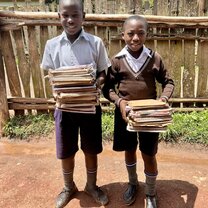 Students carrying books to the classroom