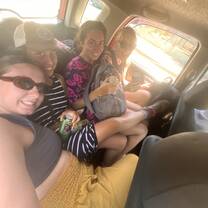 My friends and I cramming 4 people into a 3-person backseat of a taxi in Puntarenas