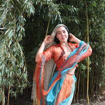 Wearing the light gown of a traditional Chinese dancer 