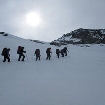 Summit snowy peaks with rope team