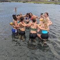 Doing yoga by the beach in the water 