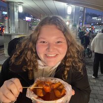 Me eating tteokbokki from a street food stand (soooo good)!