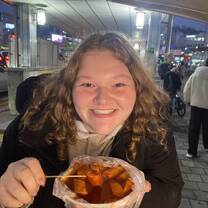 Me eating tteokbokki from a street food stand (soooo good)!