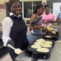 A picture of me and some of my friends making authentic tortillas during a cooking class.
