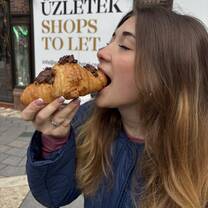 Ainsley Braun eating chocolate croissant in Budapest, Hungary, March 2025