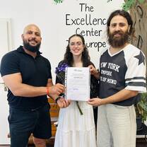 Certificate in hand and big smiles all around