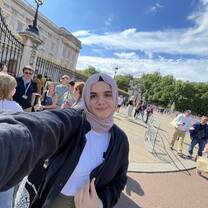 A selfie of me next to Bukingham Palace in London.