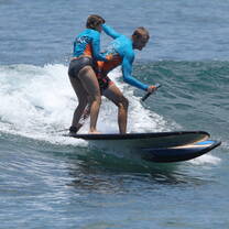 Pushing Spencer off of his surf board